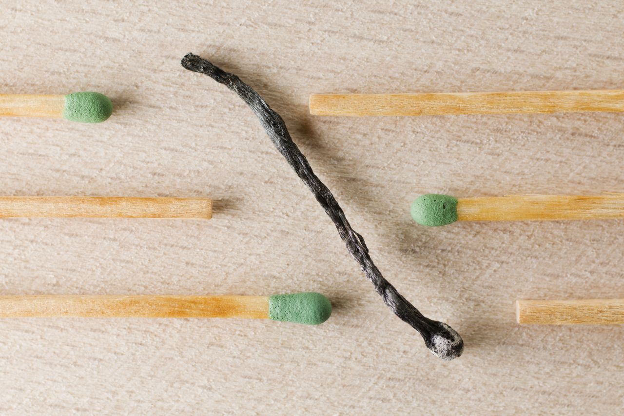 gallery-3 Charred match surrounded by green-tipped matches symbolizing burnout and contrast.